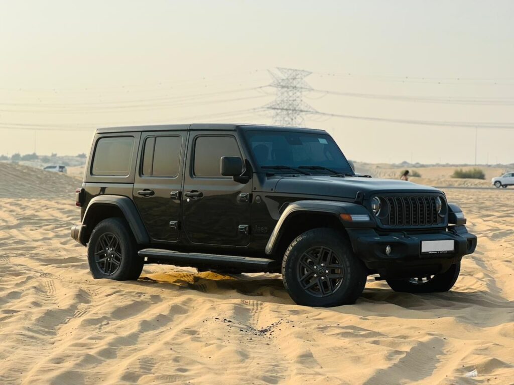 Customer driving Jeep Wrangler rental Dubai desert adventure