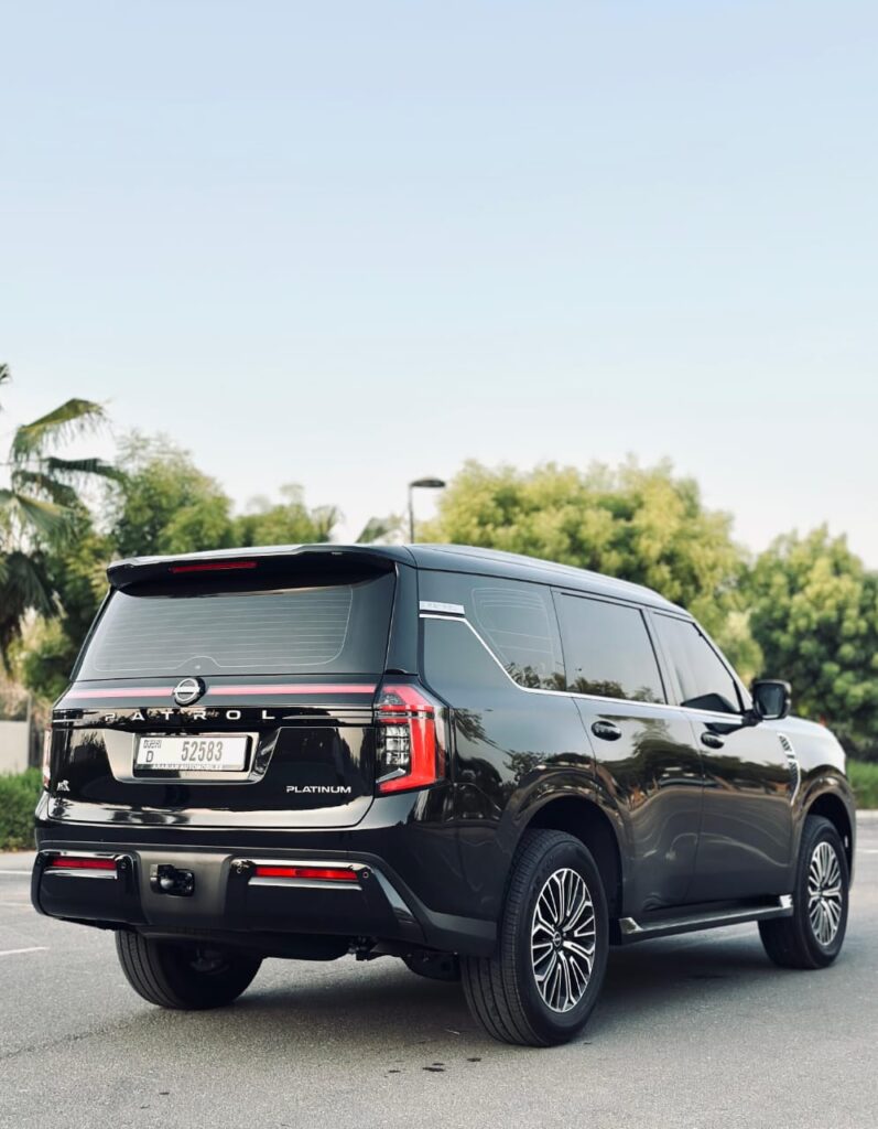 Executive driving Nissan Patrol Black rental Dubai 24/7 support